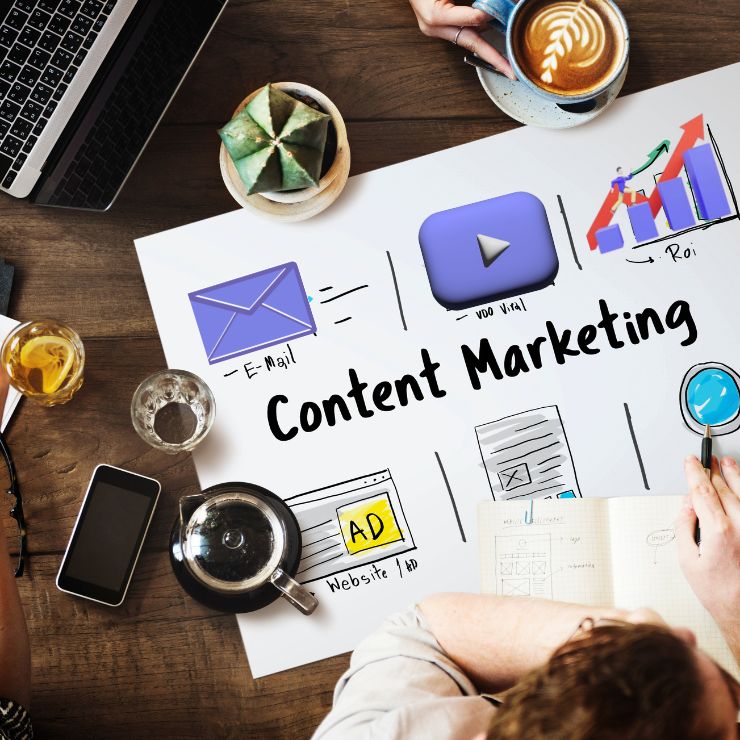 A top-down view of a team planning a content marketing strategy on a large chart paper on a table.